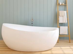freestanding bath on floorboards