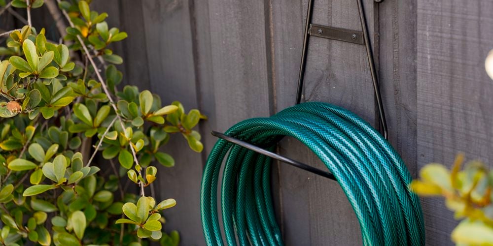 black hose holder on wall