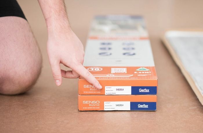 Two boxes of "Senso Rustic" vinyl flooring by Gerflor labeled with batch number 5402014
