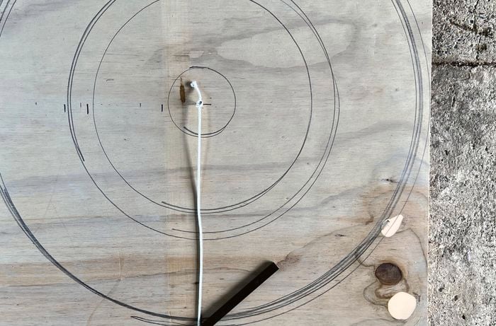 Circles marked on a piece of plywood
