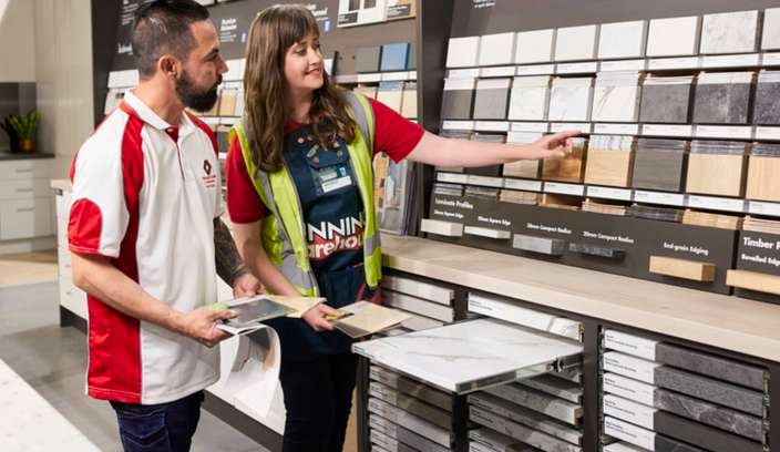 Bunnings team member assisting a customer with kitchen colours