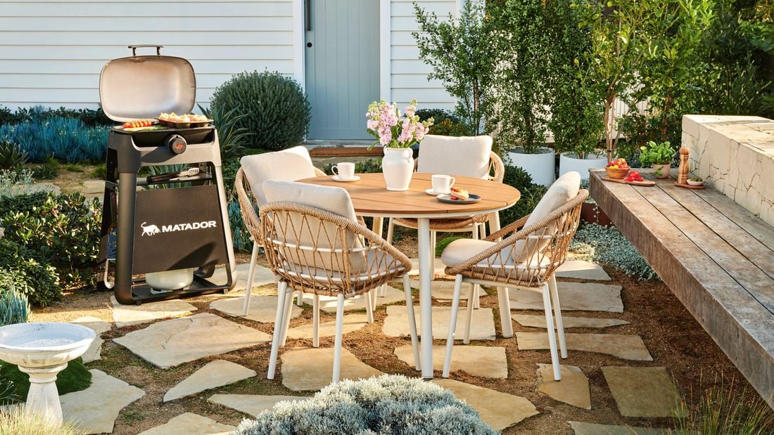 Outdoor styled setting on pavers and bbq. 