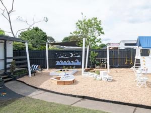 Backyard styled with play equipment 