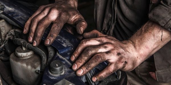 Person working on the car with dirty hands