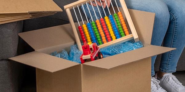 cardboard packing box with kids toys in it
