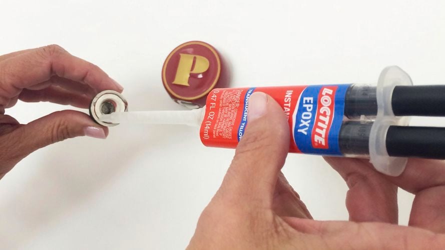 Loctite 5 Minute Epoxy being used to fix a stopper.