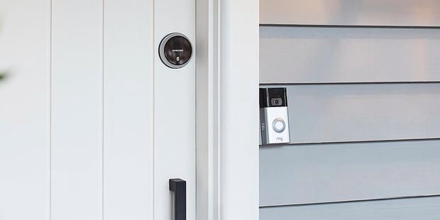 Front door with ring security doorbell. The house is weatherboard.