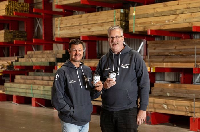 two people in a bunnings store with coffee in hand 