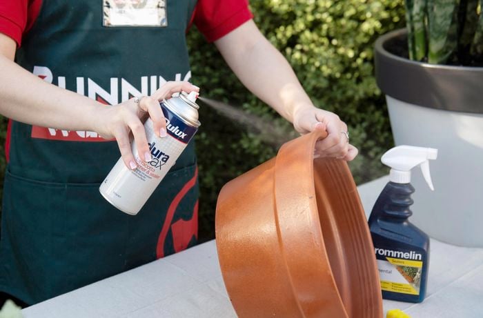 DIY - Step 3 - Team member spraying pots - How to upcycle terracotta pots - Emily.jpg