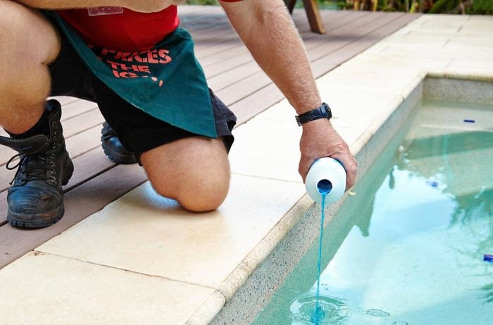 Flocculent being added to a pool