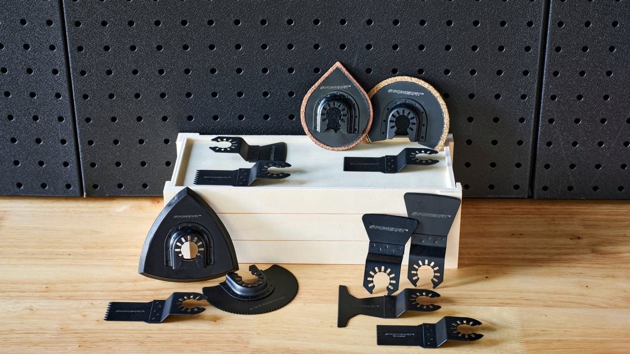 Set of multi-tool blades on top of and next to wooden box