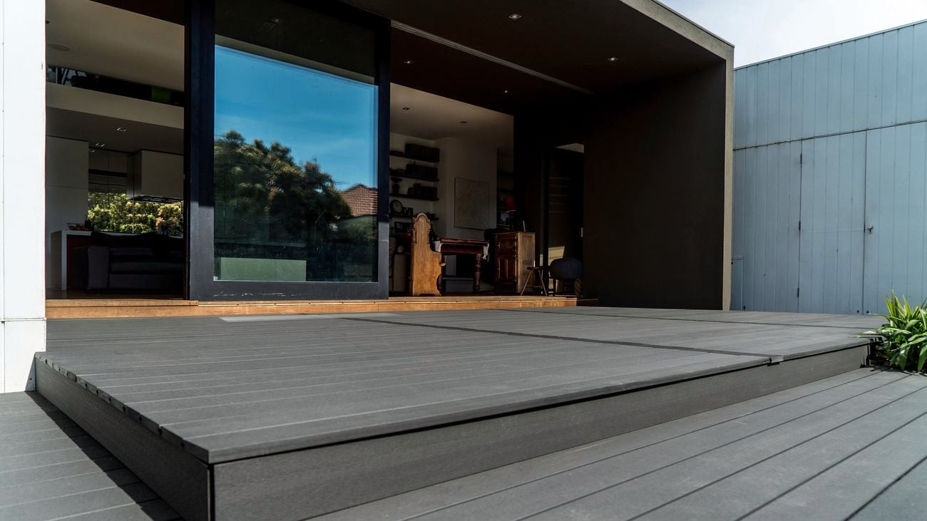 Backyard outdoor area featuring black decking.