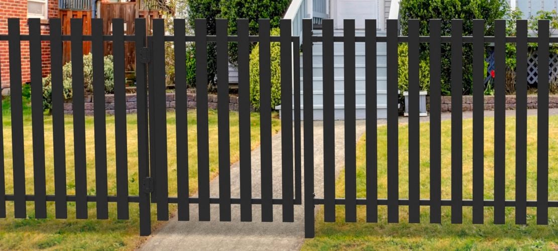 Cottage weatherboard house with blade fencing.