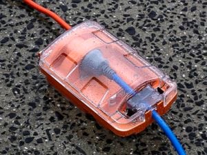Surge protector on the ground outside.