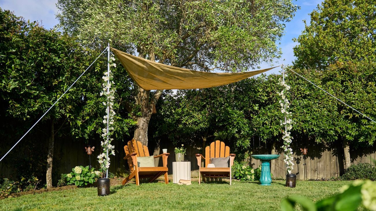 Outdoors with a shade sail over a lovely timber outdoor setting