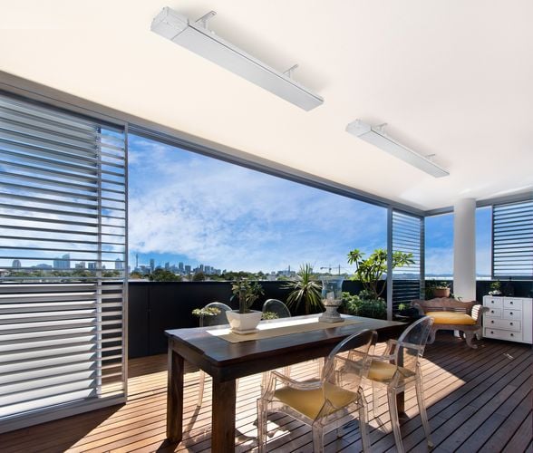 Outdoor deck dining area protected by blinds heated by roof mounted heat lamps