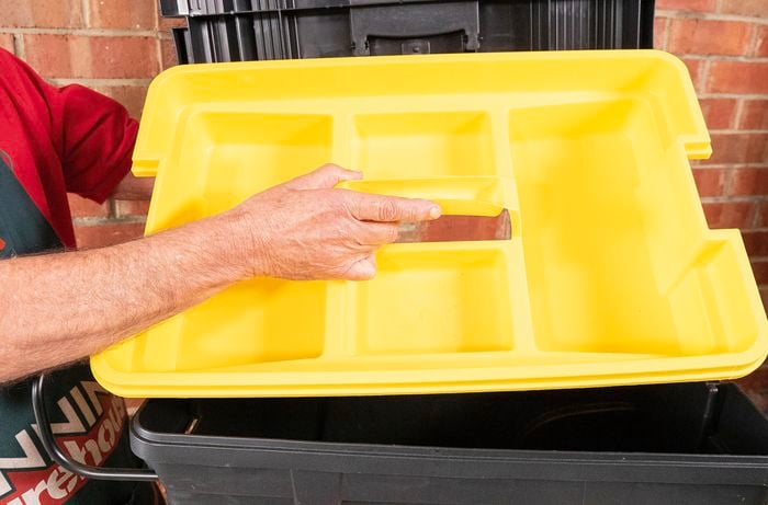 Person opening plastic box.