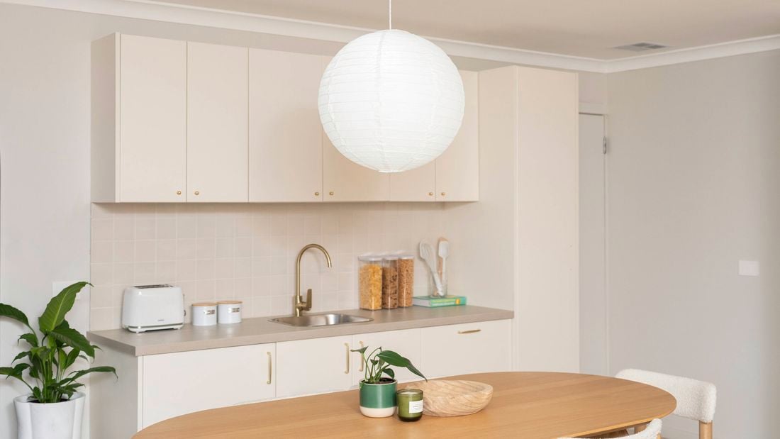 Wireless pendant light with a paper shade installed above a dining table