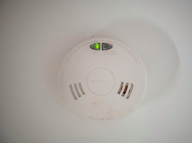 close up of a smoke alarm on a wall