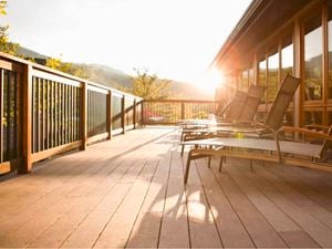 Timber deck at the back of a house with deck chairs
