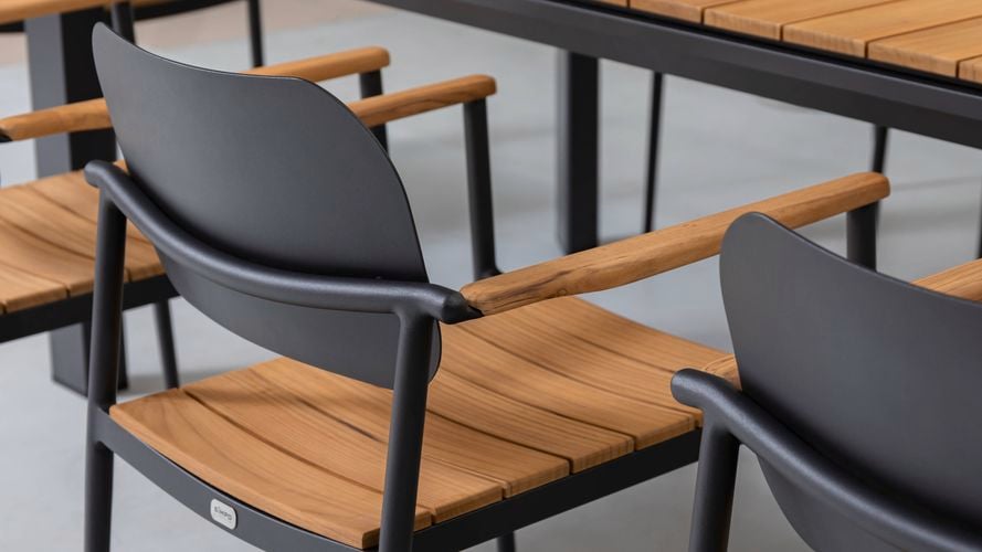Close up of an aluminium outdoor dining chair with teak seat