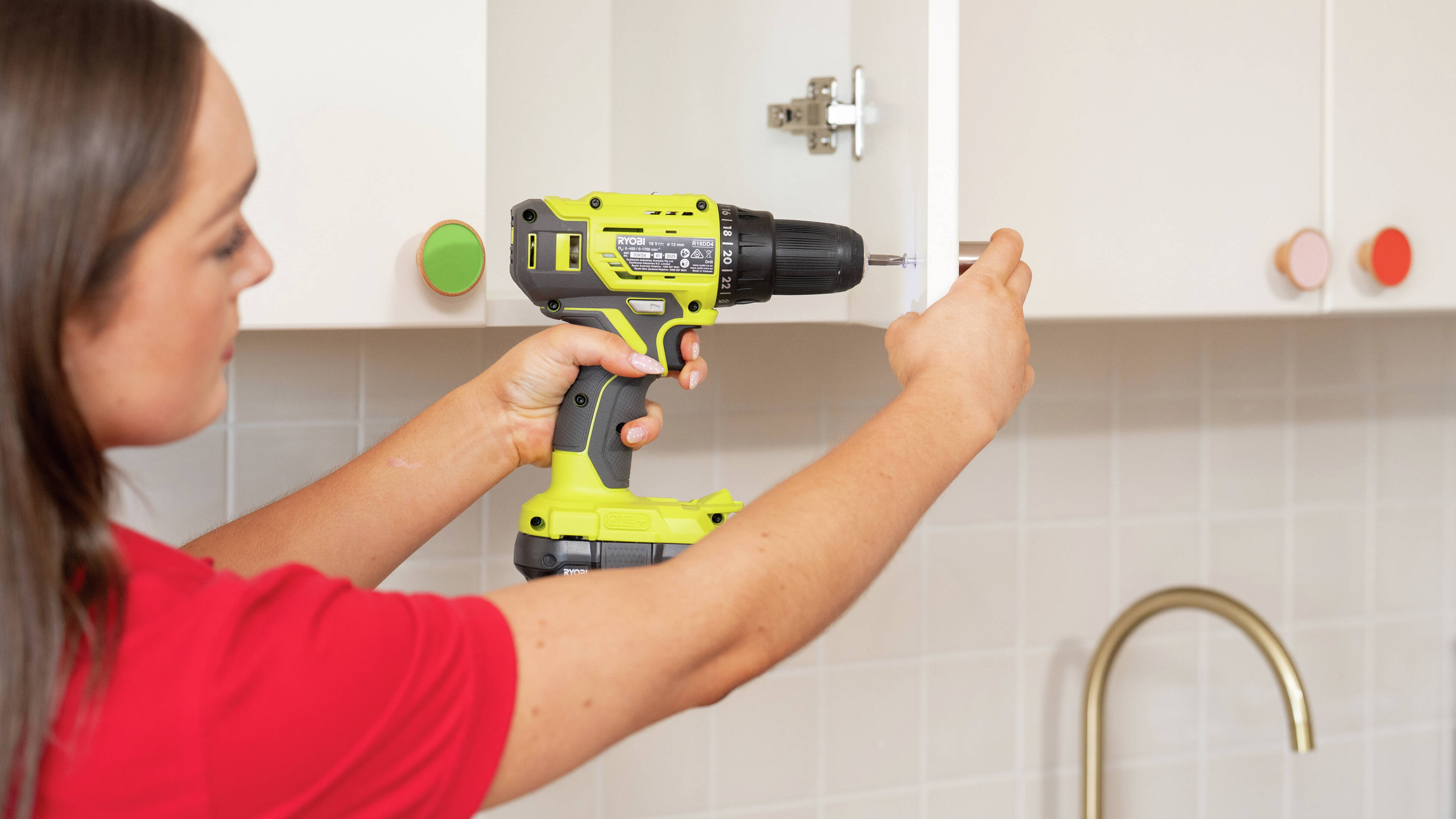  A person is using a drill driver to complete a cabinet repair, highlighting how the tool can be used for furniture assembly, home maintenance and a variety of D.I.Y. projects.