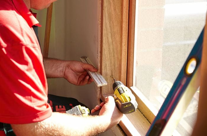 Driving the screws through your pilot holes and into the frame of the house