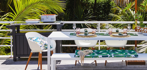 Outdoor entertaining area with white outdoor setting.