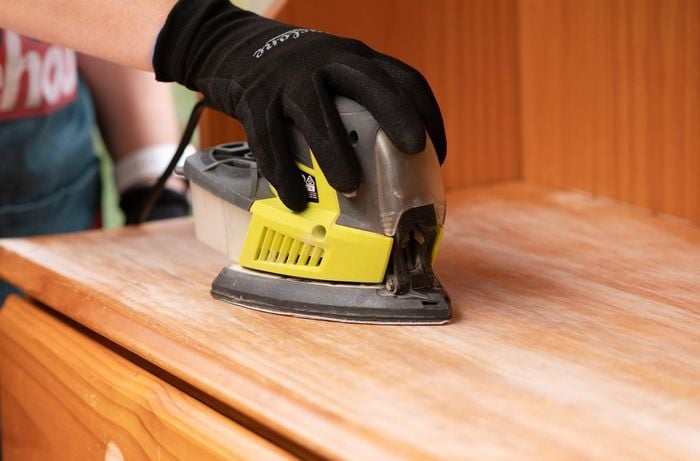 Using electric sander on timber