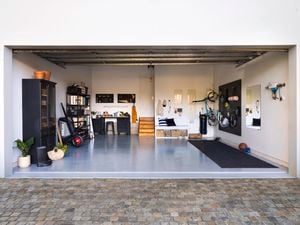 Wide shot of a garage makeover, featuring an epoxy floor, storage units and gym equipment