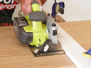 A Bunnings team member cutting through a bamboo benchtop