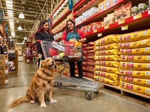 Team member with customer shopping for dog food in pets isle.