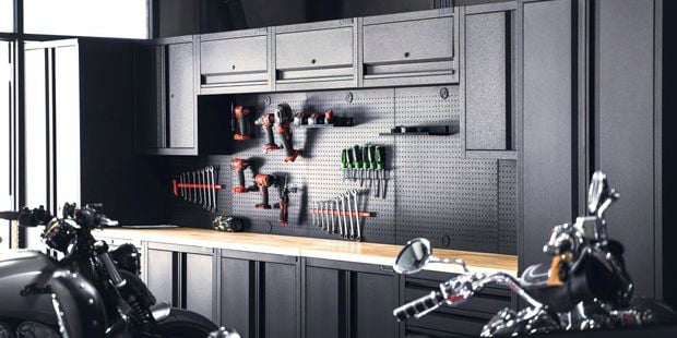 Ironheart Garage featuring the Pinnacle Pro Series Storage Stations and various pegboard hooks.