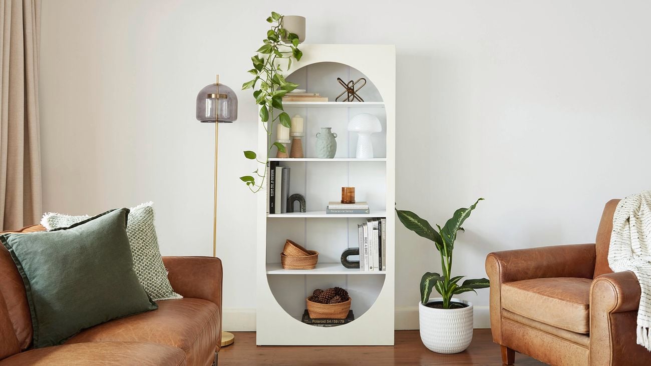 Bookcase styled with home decor objects.