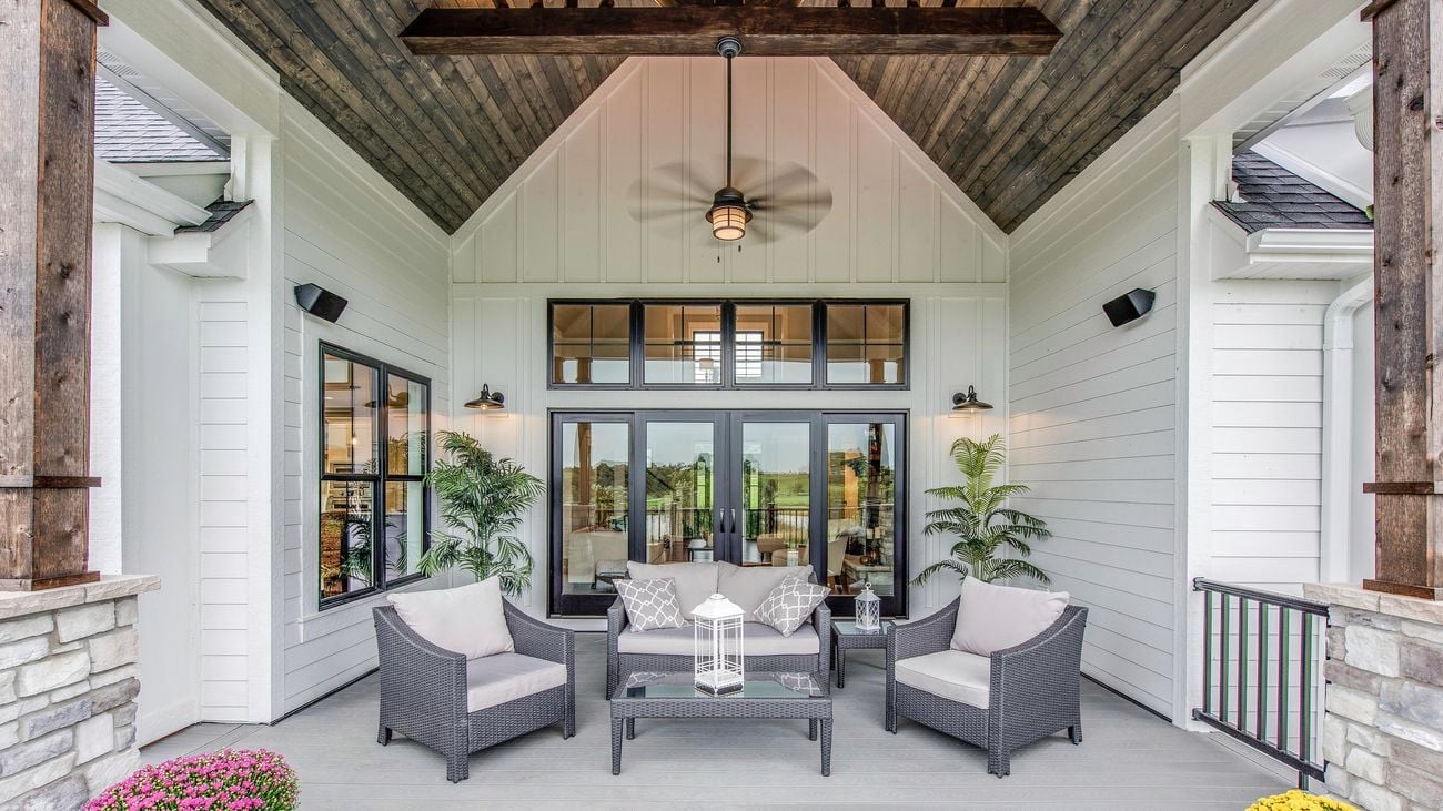 Alfresco deck living space with outdoor lounge seat and an exterior ceiling fan
