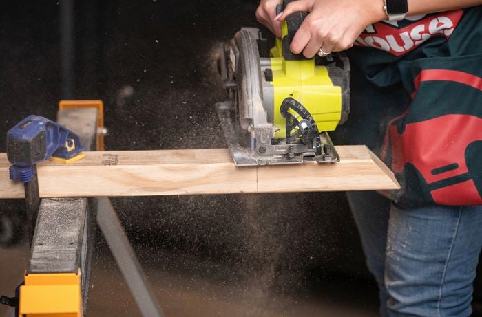 Team Member cutting framing pine