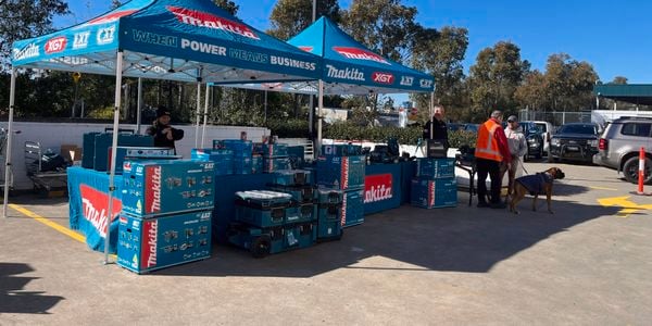 Makita pop‑up marquee with power tool displays set up outside a Bunnings Trade warehouse during a supplier demo event.