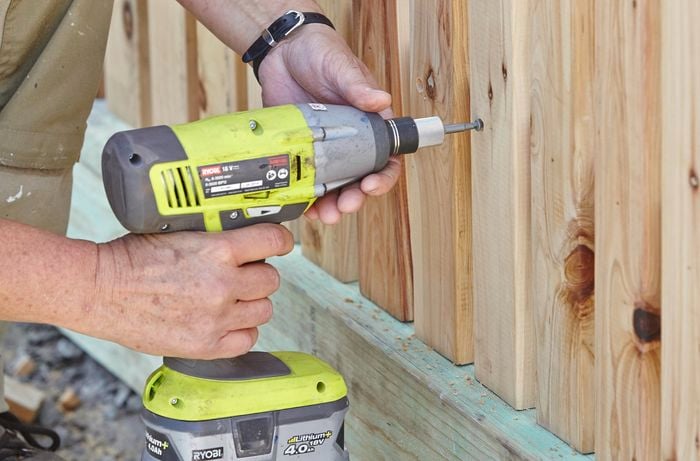 A hole being drilled into a fence paling