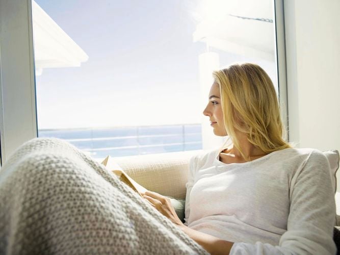 lady looking outside through a window