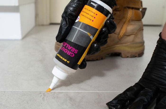 Apply the grout sealer to a tiled floor