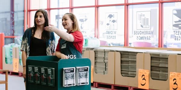 Bunnings door greeter helping a customer.