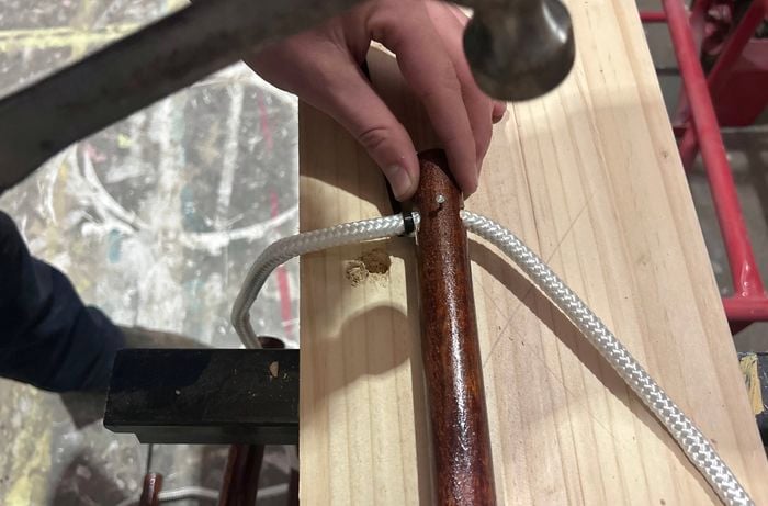 Nails being hammered into a hanging towel rail