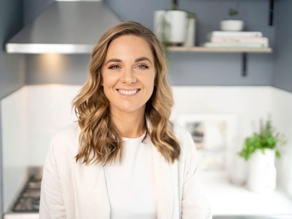 Lucy Glade-Wright of Hunting for George standing in a kitchen.