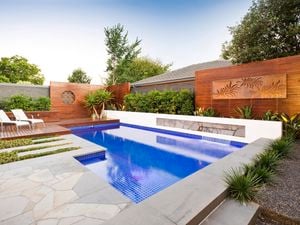 Pool with decking, timber decorative screening and concrete edging