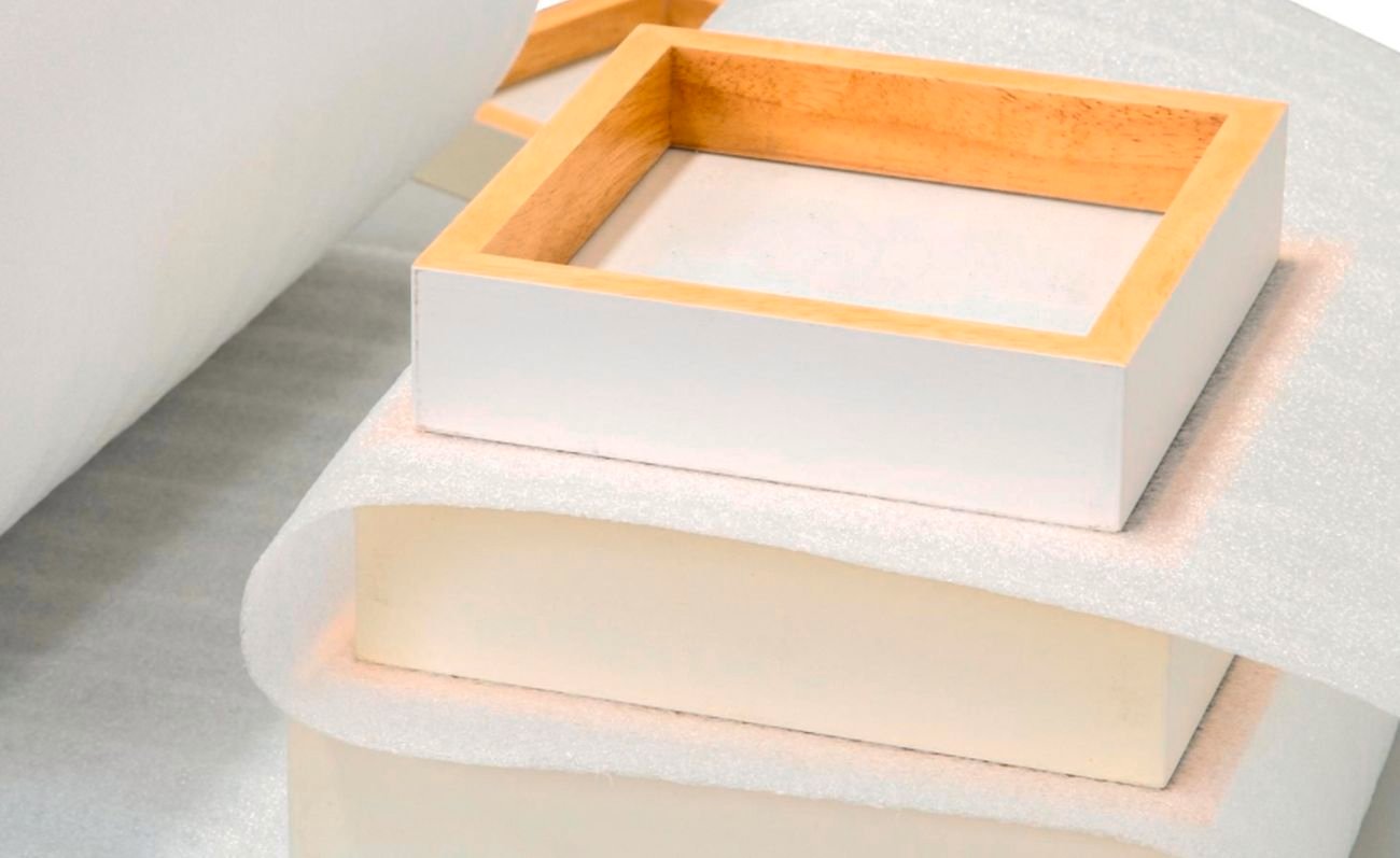 Wrap & Move protective foam wrap between books and a frame