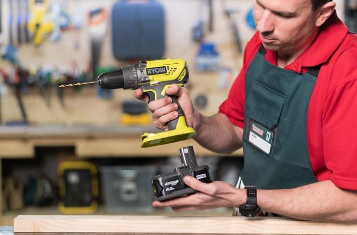 Team member showing the battery pack of a power drill