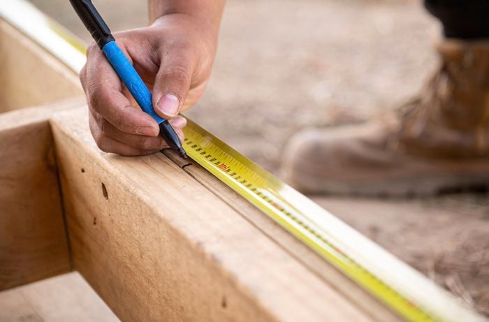 a subfloor being measured and marked for boards