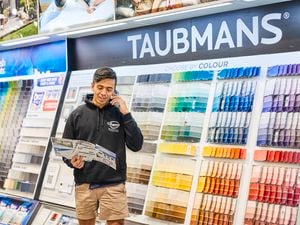    a {     text-decoration: none;     color: #464feb; } tr th, tr td {     border: 1px solid #e6e6e6; } tr th {     background-color: #f5f5f5; }     A person standing in front of a Bunnings paint display wall while holding a brochure and talking on the phone.