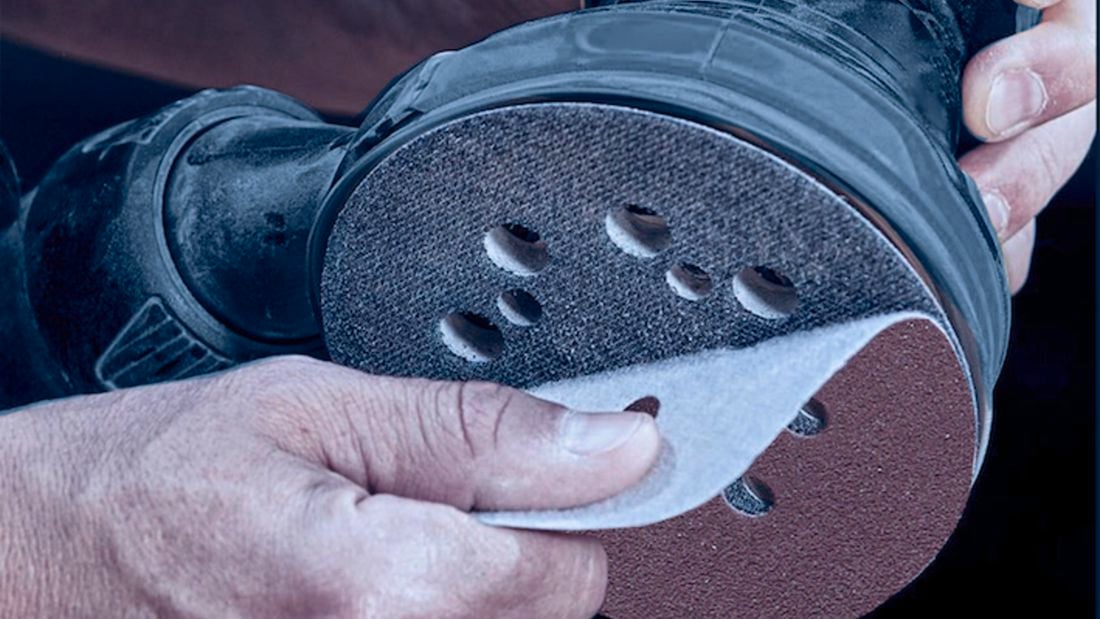 Close up of applying a IRWIN sanding disc with the hook-and-loop backing.