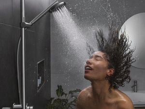 Girl washing her hair in the shower.